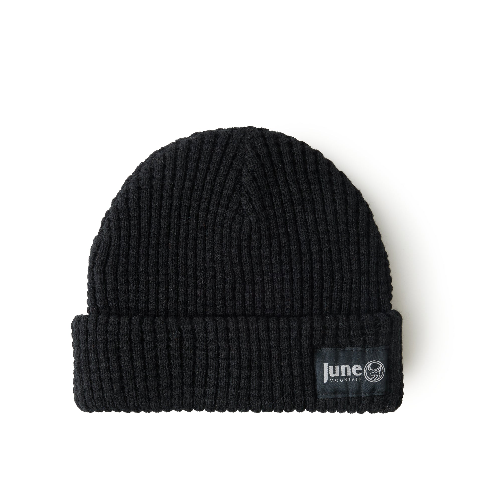 Black knit beanie with a visible brand label on a white background